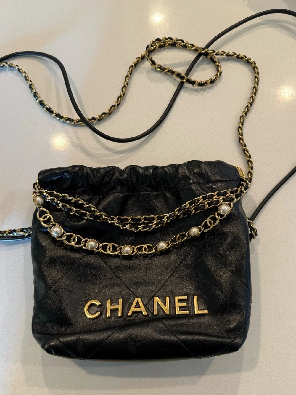 CHANEL 22 Black Quilted Leather Crossbody with Pearl-Trim Chain